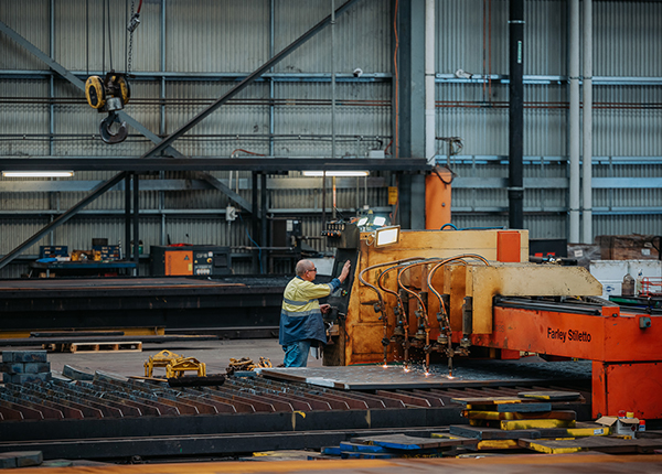 Man operating an oxy cutting machine for steel